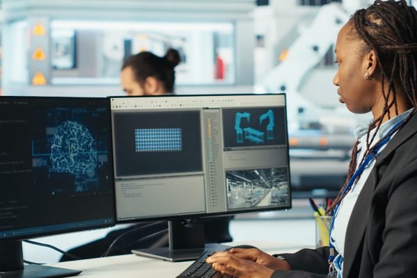Photovoltaics factory programmer using AI technology to monitor system performance. Solar panels manufacturing plant developer using artificial intelligence to track energy production, camera B